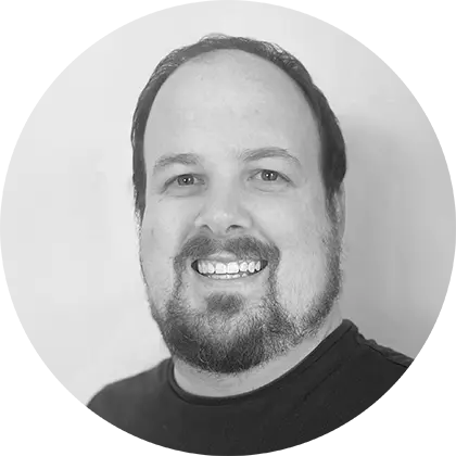 Chris Rowe black and white headshot over plain background, cropped to face in circle